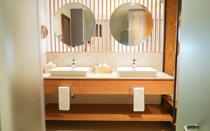 Elegant luxury bathroom layout showcasing double independent washbasin vanities with premium boutique bath amenities at Kadun Hotel Boutique.