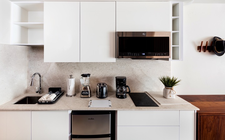 Fully equipped luxury kitchenette inside the studio suite, featuring modern sleek cabinetry, built-in premium appliances, and a marble countertop at Kadun Hotel Boutique.