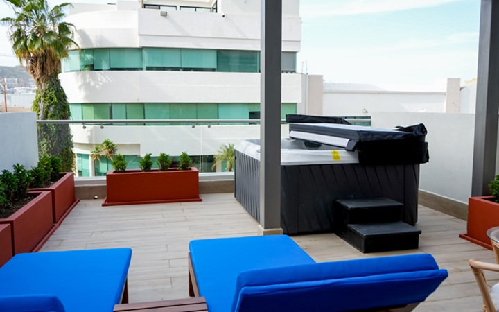 Private outdoor terrace featuring an inviting built-in hot tub jacuzzi and premium lounge chairs at Kadun Hotel Boutique.